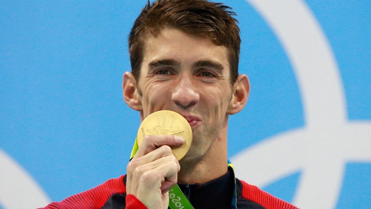 Michael Phelps kissing gold medal