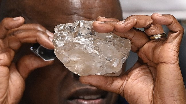 President of Botswana examining massive diamond