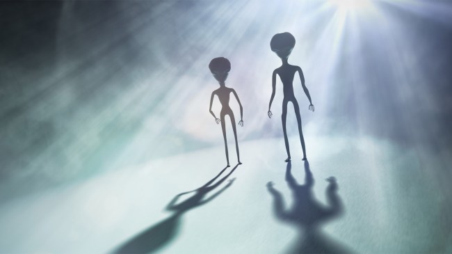 silhouettes of aliens in bright light