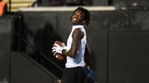 Travis Hunter warms up before a Colorado football game.