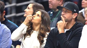 Danica Patrick and Aaron Rodgers watch the Milwaukee Bucks