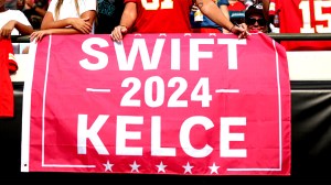 Kansas City Chiefs fan holds a campaign sign for Taylor Swift and Travis Kelce