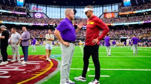 Head coaches Lincoln Riley and Brian Kelly chat before a game between LSU and USC.