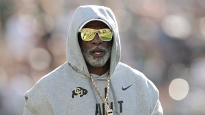 Colorado football coach Deion Sanders on the field before a game against Colorado State.