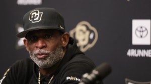 Deion Sanders talks to the media after a Colorado football game.