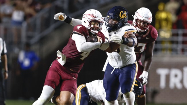 Florida State QB DJ Uiagalelei is tackled by a Cal defender.