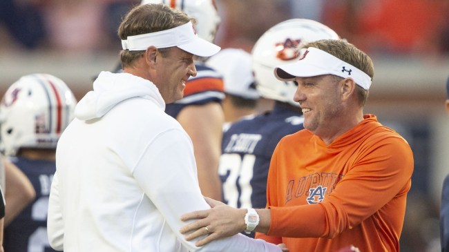 Lane Kiffin and Hugh Freeze shake hands before a game between Ole Miss and Auburn.