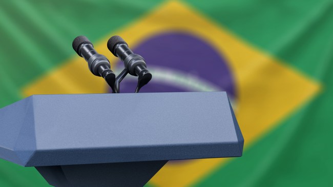 Podium in front of Brazilian flag