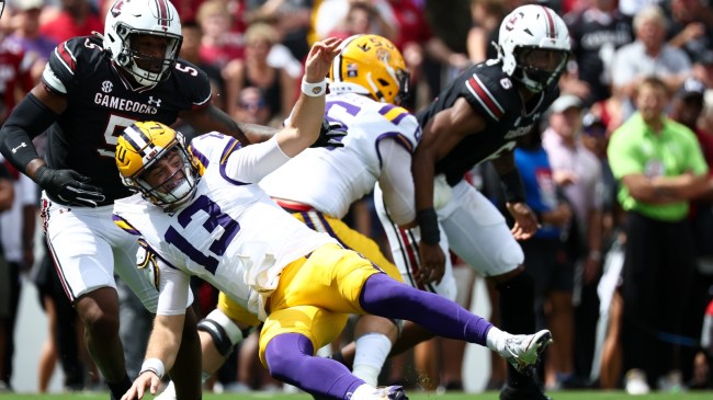 LSU QB Garrett Nussmeier is tackled by a South Carolina defender.