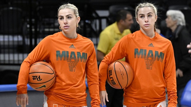 Haley and Hanna Cavinder on the floor before a Miami basketball game.