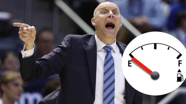 Basketball coach Mark Pope calls out a play from the sidelines.