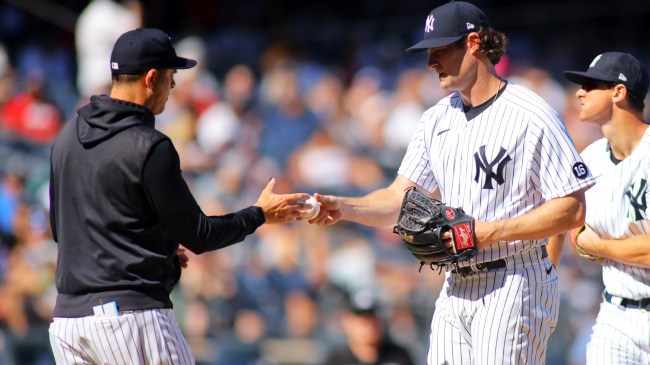 Yankees pitcher Gerrit Cole hands the ball to manager Aaron Boone.