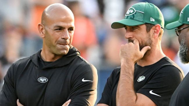 aaron rodgers and robert saleh speaking on the sidelines