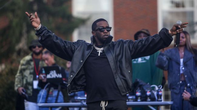 diddy raising his arms while performing