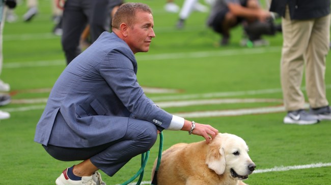 Kirk Herbstreit and his dog, Ben, on the field before a game between Georgia and Alabama.