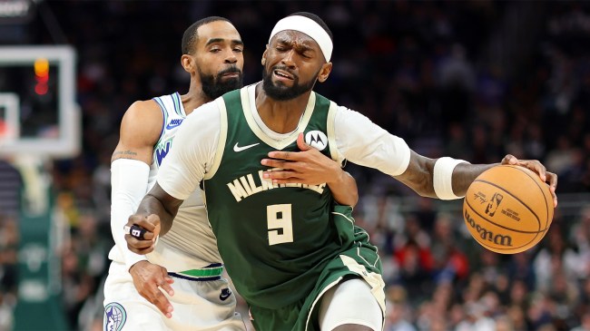 Bobby Portis of the Milwaukee Bucks drives around Mike Conley of the Minnesota Timberwolves