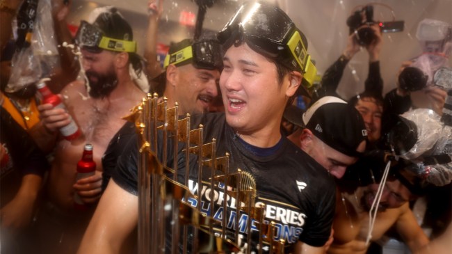 Los Angeles Dodgers Shohei Ohtani holds World Series trophy in locker celebration
