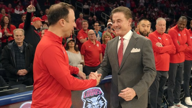 Rick Pitino and Richard Pitino shake hands before a basketball game between St. John's and New Mexico.