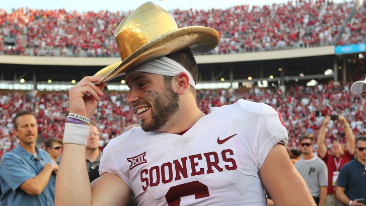Baker Mayfield wearing Golden Hat Trophy