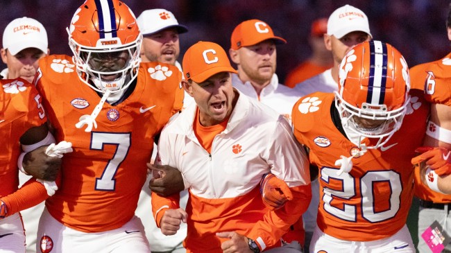 Clemson football coach Dabo Swinney enters the field with his team.