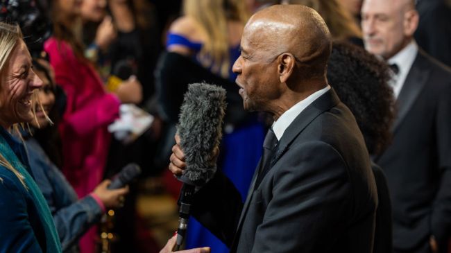 denzel washington holding a microphone