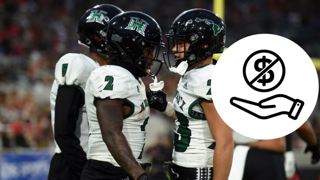 Hawaii football players celebrate after scoring a touchdown.
