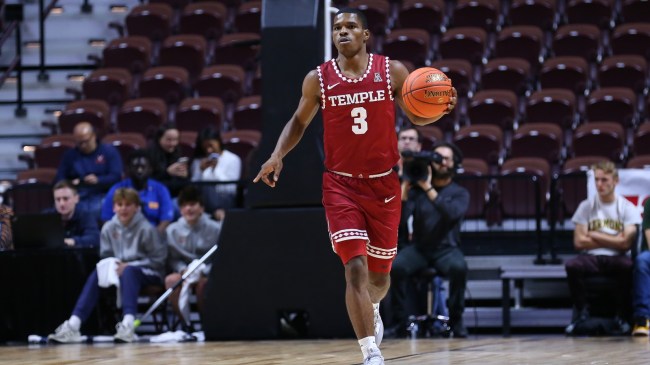 Temple basketball player Hysier Miller dribbles up the court.