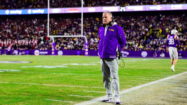 LSU football coach Brian Kelly stands on the sidelines.