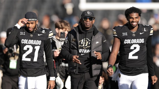 Deion Sanders walks with sons Shedeur and Shilo on Senior Day.