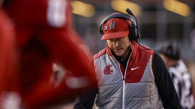 Washington State football coach Jake Dickert walks the sidelines.