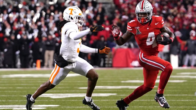 Ohio State wide receiver Jeremiah Smith runs by a Tennessee Vols defender.