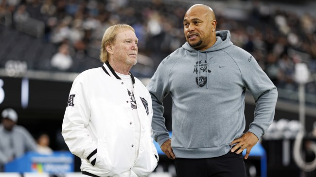 Raiders owner Mark Davis stands beside coach Antonio Pierce.