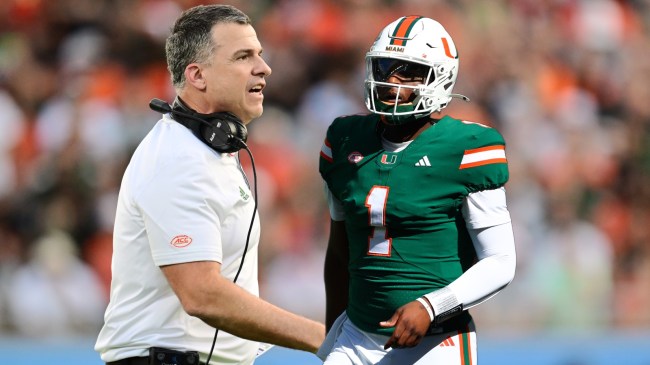 Miami football coach Mario Cristobal pictured beside QB Cam Ward.