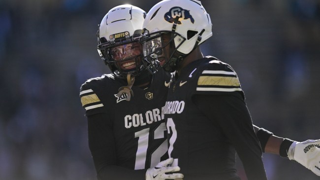 Colorado football players Shedeur Sanders and Travis Hunter on the field.