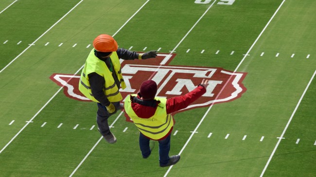 Construction workers over a background of Kyle Field.