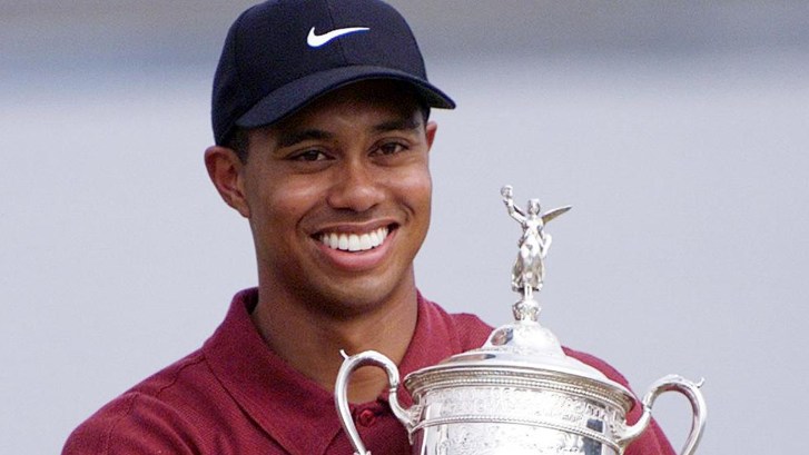 Tiger Woods holding US Open trophy after winning in 2000