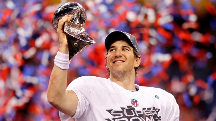 Eli Manning holding Lombardi Trophy