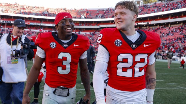 Jake Pope walks off the field with Georgia Bulldogs teammate Nate Frazier.