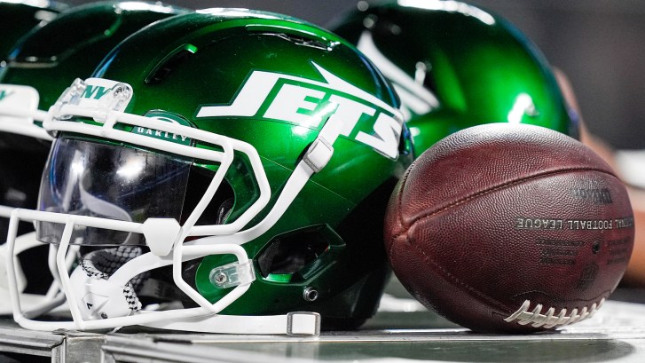 Jets helmet next to football