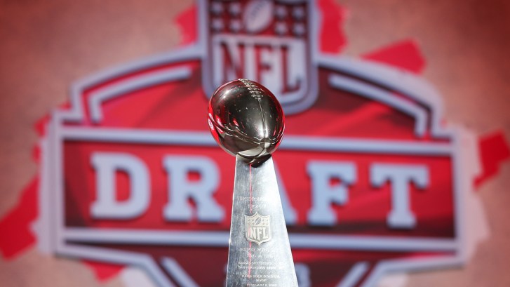 Lombardi Trophy in front of NFL Draft logo