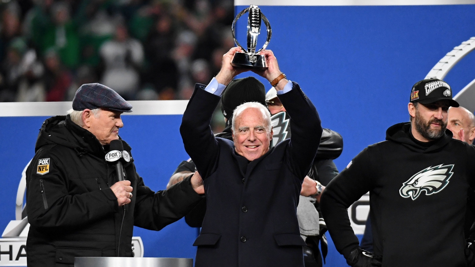 Philadelphia Eagles owner Jeffrey Lurie holding up championship trophy