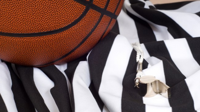 A basketball sits on top of an official's jersey.