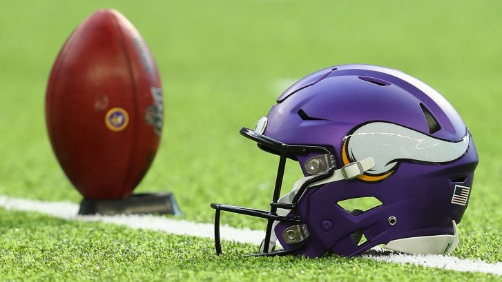 Vikings helmet next to football