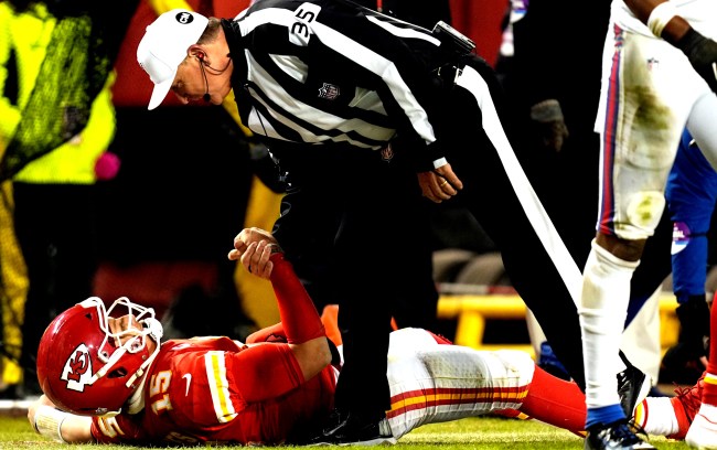 chiefs qb Patrick Mahomes gets help up from the referee Terrell Owens