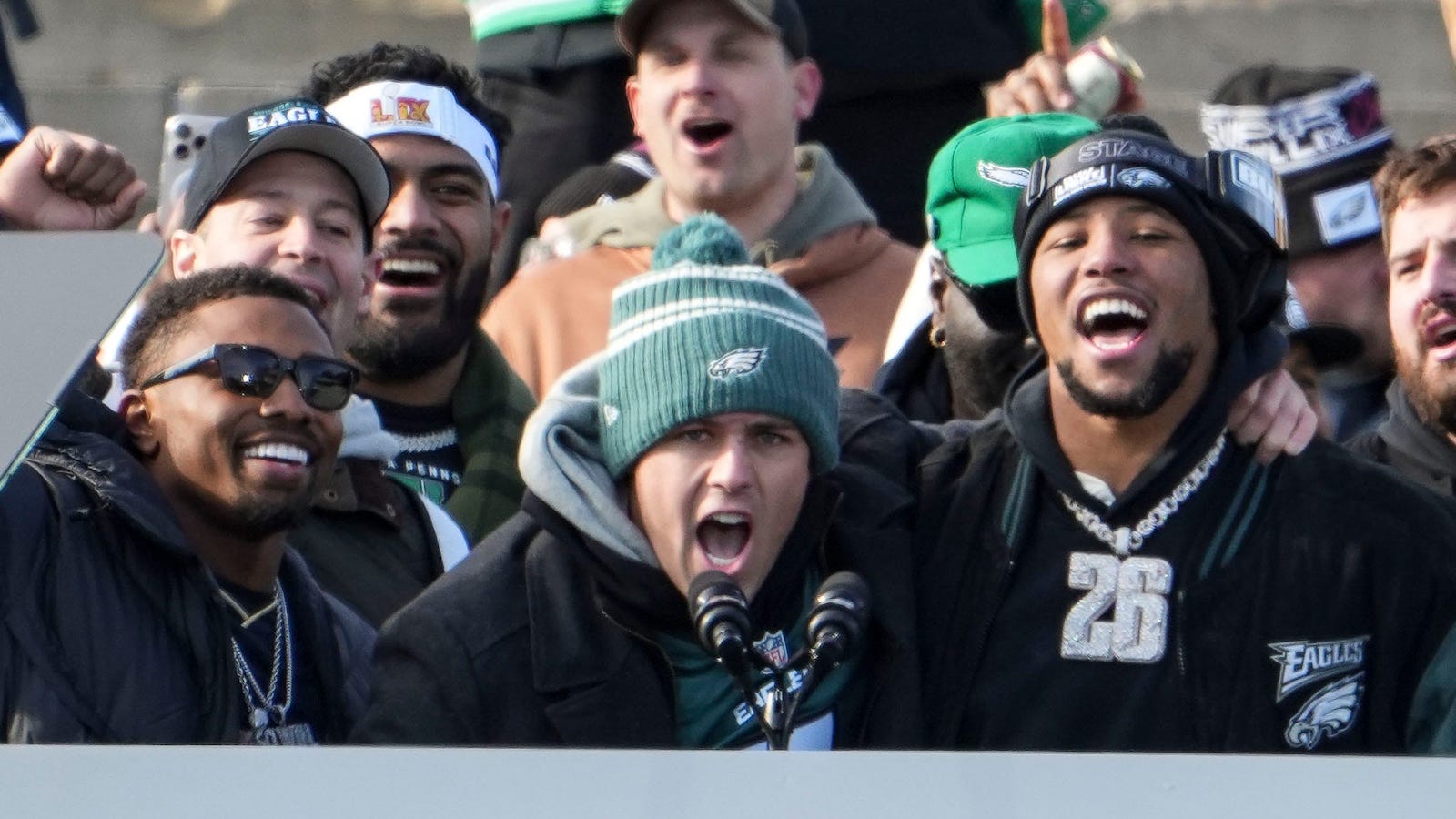 Eagles running back Saquon Barkley (right) at the podium during the Philadelphia Eagles Super Bowl celebration in front of the Philadelphia Museum of Art, Friday, Feb. 14, 2025.