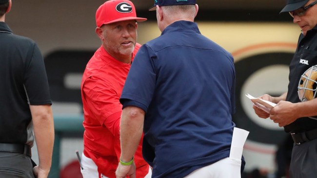Georgia baseball coach Wes Anderson shakes hands at home plate.