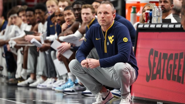 West Virginia basketball coach Darian DeVries watches from the sidelines.