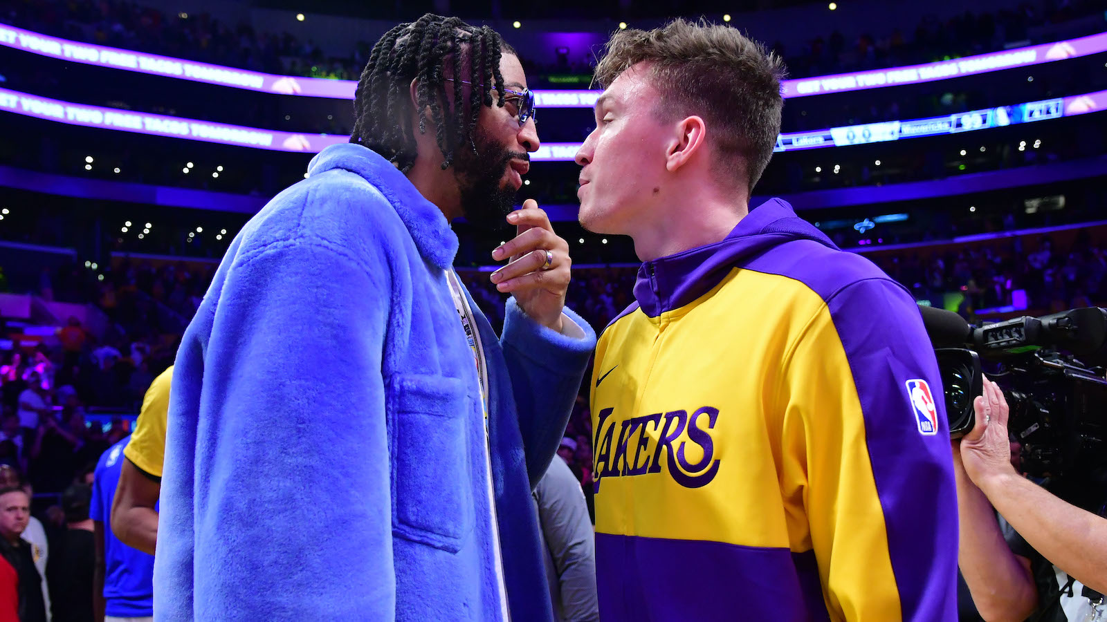 Feb 25, 2025; Los Angeles, California, USA; Dallas Mavericks forward Anthony Davis (left) reacts with Los Angeles Lakers guard Dalton Knecht (right) after the game at Crypto.com Arena. Mandatory Credit: Gary A. Vasquez-Imagn Images