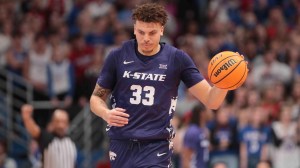 Kansas State forward Coleman Hawkins dribbles the basketball.