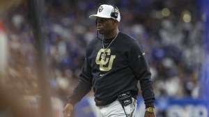 Colorado football coach Deion Sanders on the field.